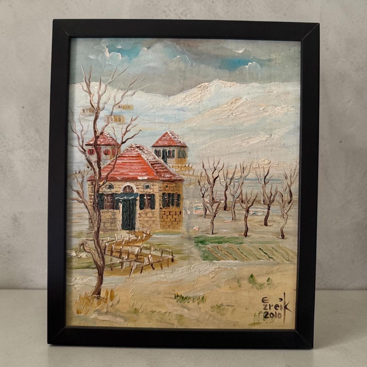 Framed painting of a Lebanese village with traditional, red-roofed houses and bare trees.